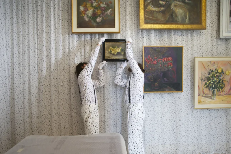 Installation view with performance We knew it would be hard to put anything on these walls, hanging of the painting by Ivana Kobilca (Rožeteje, sine anno), For Our Economy and Culture, Pavilion of Slovenia, Venice Biennial