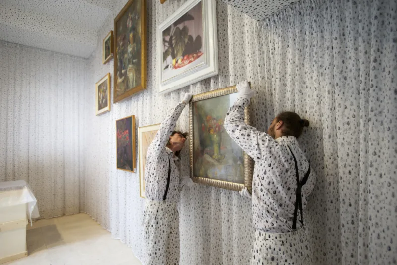 Installation view with performance We knew it would be hard to put anything on these walls, hanging of the painting by Rihard Jakopič (Anemone, 1933), For Our Economy and Culture, Pavilion of Slovenia, Venice Biennial