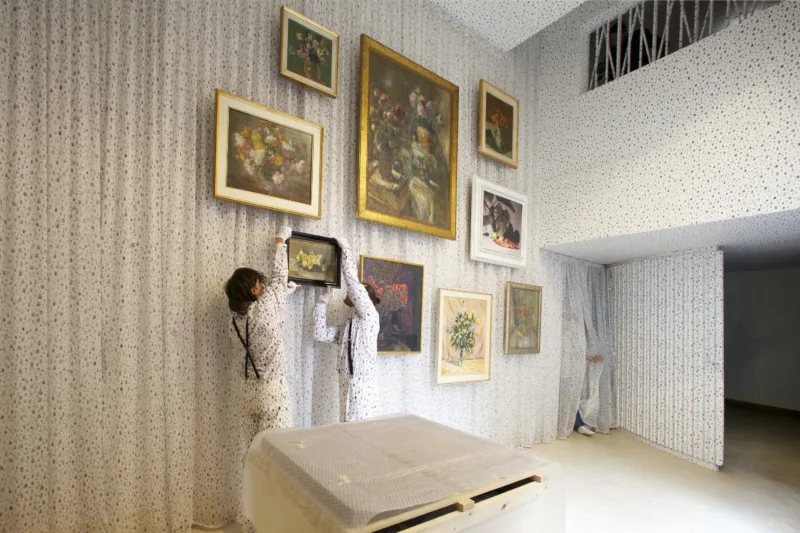 Installation view with performance We knew it would be hard to put anything on these walls, hanging of the painting by Ivana Kobilca (Rožeteje, sine anno), For Our Economy and Culture, Pavilion of Slovenia, Venice Biennial